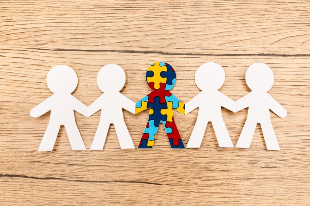 Top view of special kid with autism among another on wooden background